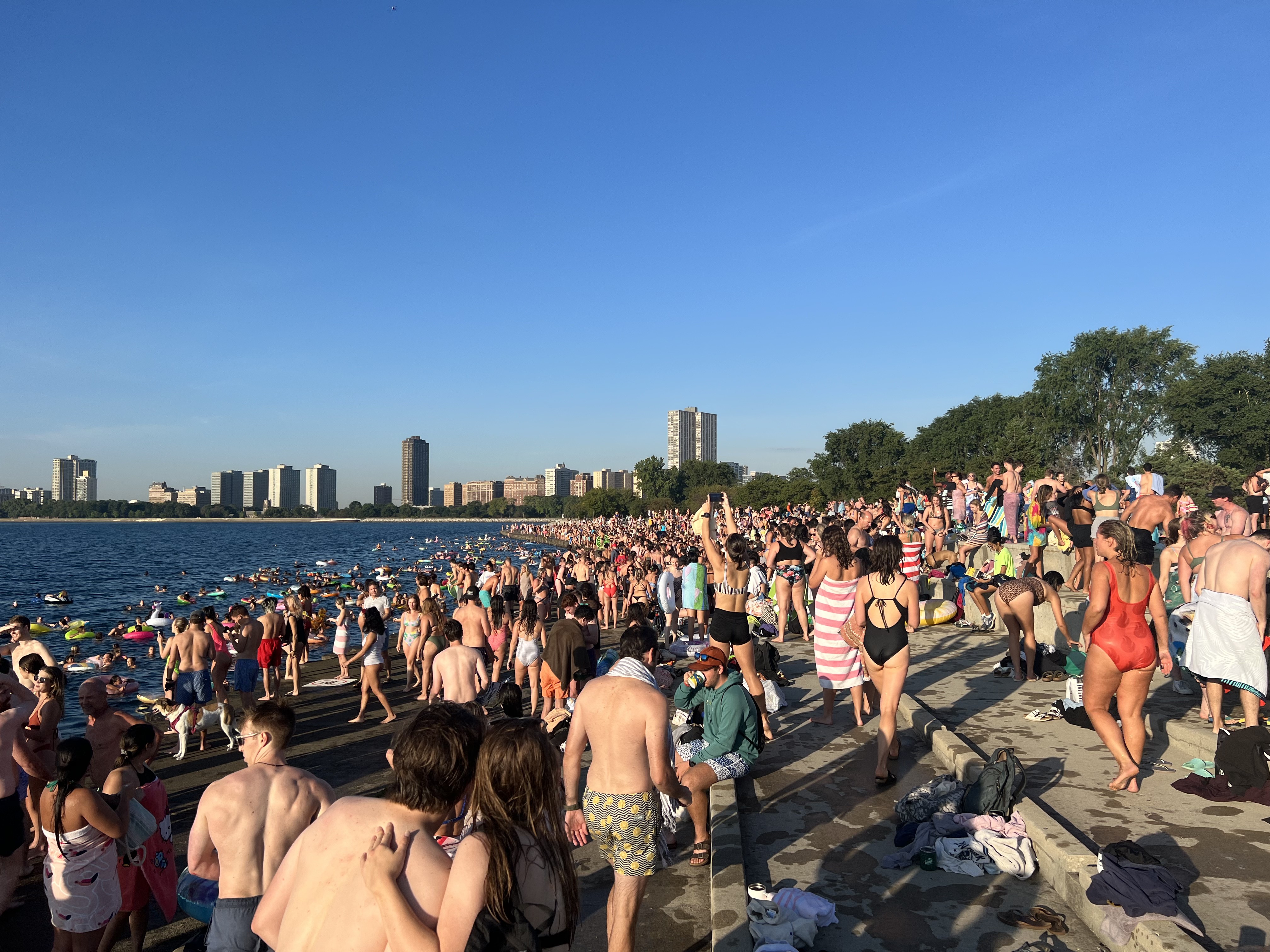 Many hundreds of people in swimsuits at a concrete beach in Chicago